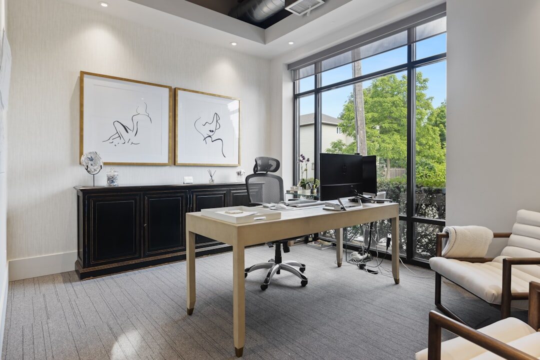 Modern newsroom office with journalists working at desks with monitors